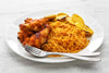 Jollof rice served with plantains and chicken wings